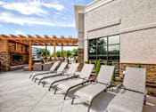 Thumbnail 7 of 25 - A row of sun loungers are on a patio.