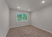 Thumbnail 12 of 20 - A room with a window and carpeted floor.