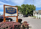 Thumbnail 1 of 20 - A sign for Royal Valley Apartments with a phone number on it.