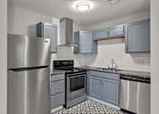 Thumbnail 18 of 20 - A kitchen with a stainless steel refrigerator, oven, and sink.