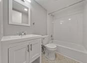 Thumbnail 20 of 20 - A white bathroom with a toilet, sink, and bathtub.