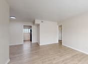 Thumbnail 4 of 14 - the spacious living room and dining room with hardwood flooring and white walls