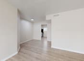 Thumbnail 3 of 14 - the spacious living room and dining room with white walls and wood flooring