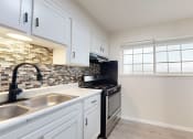 Thumbnail 6 of 14 - a kitchen with stainless steel appliances and white cabinets