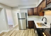 Thumbnail 23 of 39 - a kitchen with stainless steel appliances and wooden cabinets