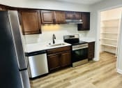 Thumbnail 22 of 39 - a kitchen with wooden cabinets and stainless steel appliances