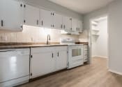 Thumbnail 26 of 39 - a kitchen with white cabinets and white appliances