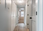 Thumbnail 28 of 39 - a hallway with white shutters and a light on the ceiling