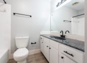 Thumbnail 29 of 39 - a bathroom with a sink and a toilet