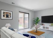 Thumbnail 12 of 39 - a living room with a sliding glass door and a tv on the wall