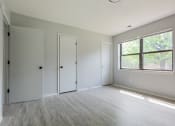 Thumbnail 18 of 39 - an empty bedroom with a large window and white walls