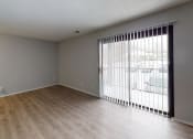 Thumbnail 16 of 39 - a bedroom with a sliding glass door and hardwood floors