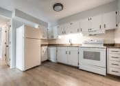 Thumbnail 27 of 39 - a kitchen with white cabinets and white appliances