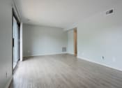 Thumbnail 10 of 39 - a bedroom with hardwood floors and grey walls