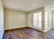 Thumbnail 8 of 28 - an empty living room with hard wood floors and a window