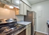Thumbnail 9 of 28 - a kitchen with stainless steel appliances and a refrigerator