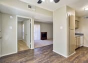 Thumbnail 1 of 28 - an empty living room and kitchen with a fireplace