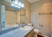 Thumbnail 14 of 28 - a bathroom with a sink and a mirror and a toilet