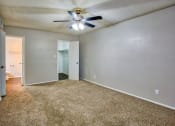 Thumbnail 16 of 28 - an empty living room with a ceiling fan