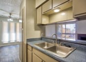 Thumbnail 2 of 28 - a kitchen with a sink and a window