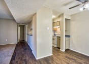 Thumbnail 3 of 28 - the living room and kitchen of an apartment with a hard wood floor