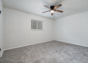 Thumbnail 4 of 8 - an empty room with a ceiling fan and a window