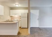 Thumbnail 6 of 12 - View of living room and kitchen with sink, stove, refrigerator, and cabinets