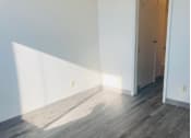 Thumbnail 4 of 21 - an empty room with white walls and wood floors