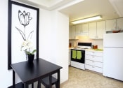Thumbnail 3 of 21 - kitchen with white cabinets with black table