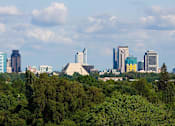 Thumbnail 5 of 5 - A daytime photograph of the Sacramento skyline above trees