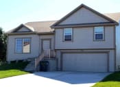 Thumbnail 2 of 21 - a white house with a driveway and a garage door