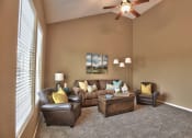 Thumbnail 6 of 21 - a living room with a couch and chairs and a ceiling fan