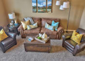 Thumbnail 7 of 21 - a living room with a couch and chairs and a coffee table
