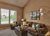 Thumbnail 8 of 21 - a living room with a couch and a table