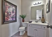 Thumbnail 8 of 14 - a bathroom with a toilet sink and a mirror