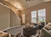 Thumbnail 9 of 21 - a living room with couches and chairs and a table