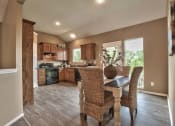 Thumbnail 10 of 21 - a kitchen and dining room with a table and chairs