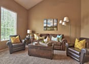 Thumbnail 11 of 25 - a living room with leather furniture and a large window