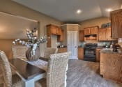 Thumbnail 12 of 21 - a dining room with a table and chairs