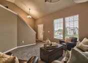 Thumbnail 13 of 25 - a living room with couches and chairs and a table