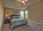 Thumbnail 17 of 21 - a bedroom with a bed and a ceiling fan