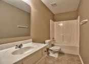 Thumbnail 19 of 21 - a bathroom with a sink toilet and a shower