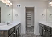 Thumbnail 16 of 32 - A bathroom with two sinks and a large mirror.