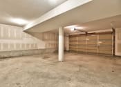 Thumbnail 21 of 21 - the interior of a garage in a house with a closed garage door