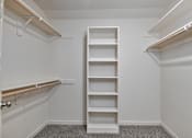 Thumbnail 18 of 32 - A white closet with shelves and a door.