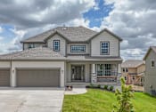 Thumbnail 1 of 52 - A house with a grey roof and a garage door.