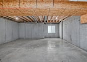 Thumbnail 31 of 32 - A room with a window and a concrete floor.