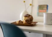 Thumbnail 25 of 33 - a plate with a muffin and a cup of coffee on a table