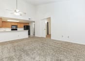 Thumbnail 4 of 13 - A room with a carpeted floor and a ceiling fan.