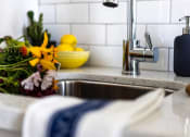 Thumbnail 17 of 33 - a kitchen sink with a bowl of lemons in the background